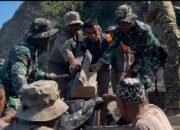 Prajurit TNI membantu warga menyalurkan bantuan logistik pascagempa di Flores, NTT